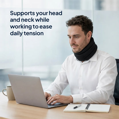 Man wearing the neck support while working at a desk